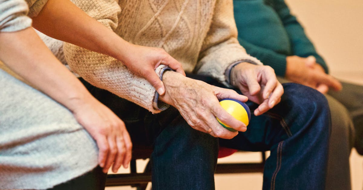 Senior using stress ball for arthritis therapy