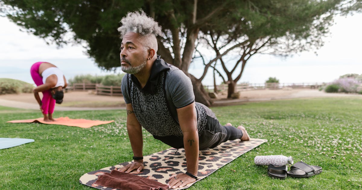 Seniors exercising outdoors with yoga